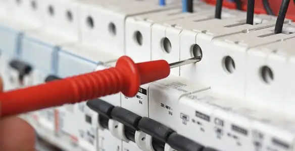 Electrical contractor testing circuit breakers during electrical repair in Sun City, AZ