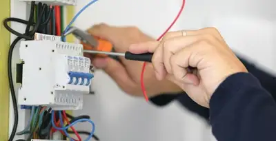 Electrician installing and adjusting circuit breakers in an electrical panel in Glendale, AZ