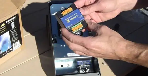 Electrician installing whole home surge protection unit inside main electrical panel in Glendale, AZ