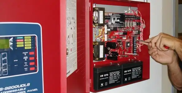 fire alarm installation service showing technician configuring fire alarm control panel in Glendale, AZ