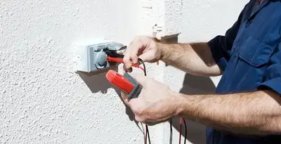 Electrician performing home electrical outlet and wiring inspection in Glendale, AZ