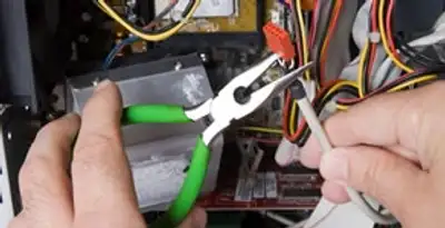 Licensed electrical contractor performing electrical repair with tools in Sun City, AZ