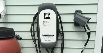 Outdoor electric vehicle charger installation on residential wall in Glendale, AZ